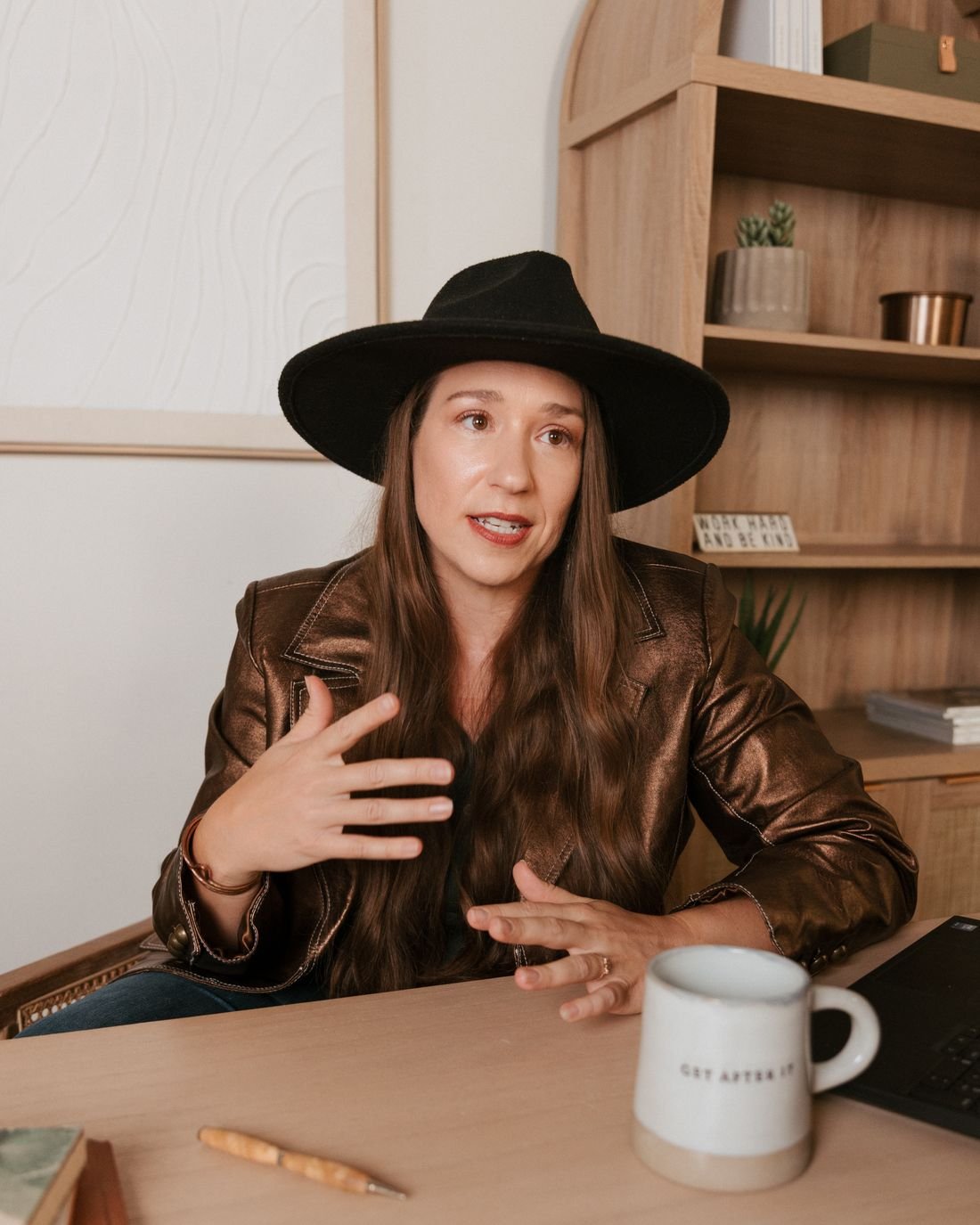Kristin Winstanley explaining something with her hands at her desk