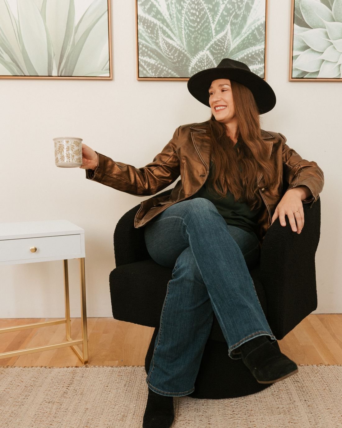 Kristin Winstanley raising her coffee mug from an armchair